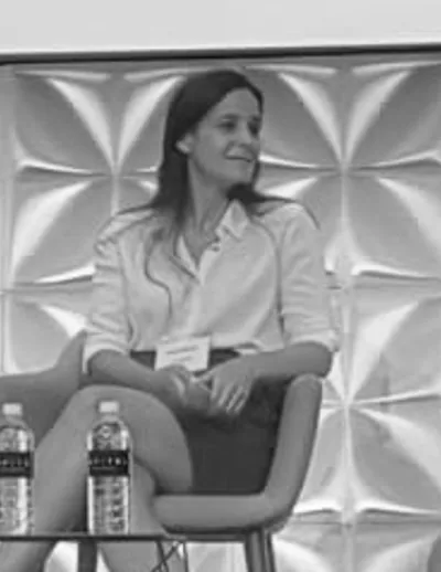 Carolina seated in a meeting room